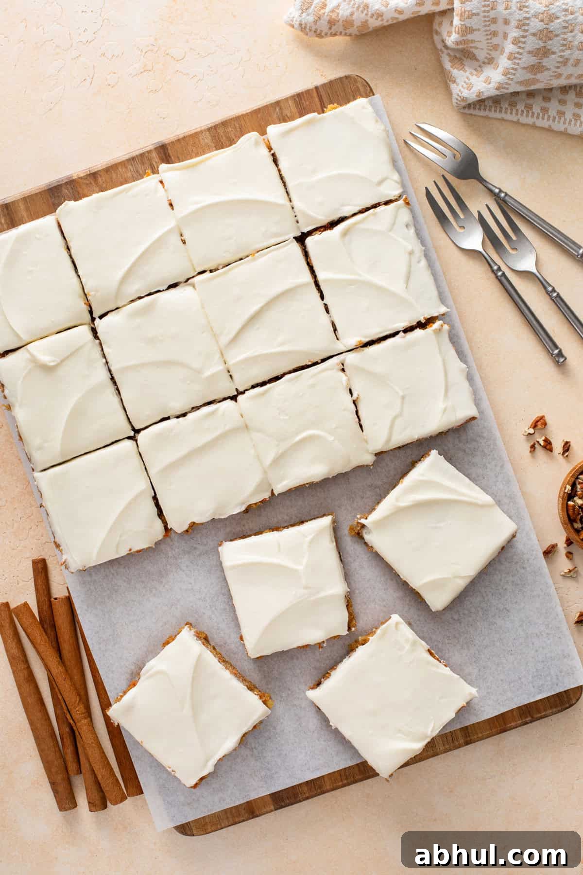 Overhead view of sliced carrot cake bars topped with cream cheese frosting.