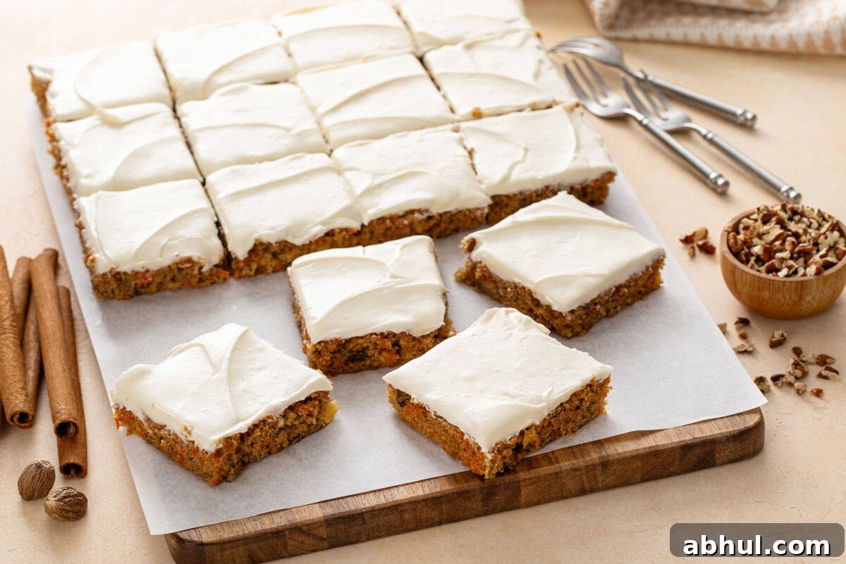 Sliced carrot cake bars on a wooden board.