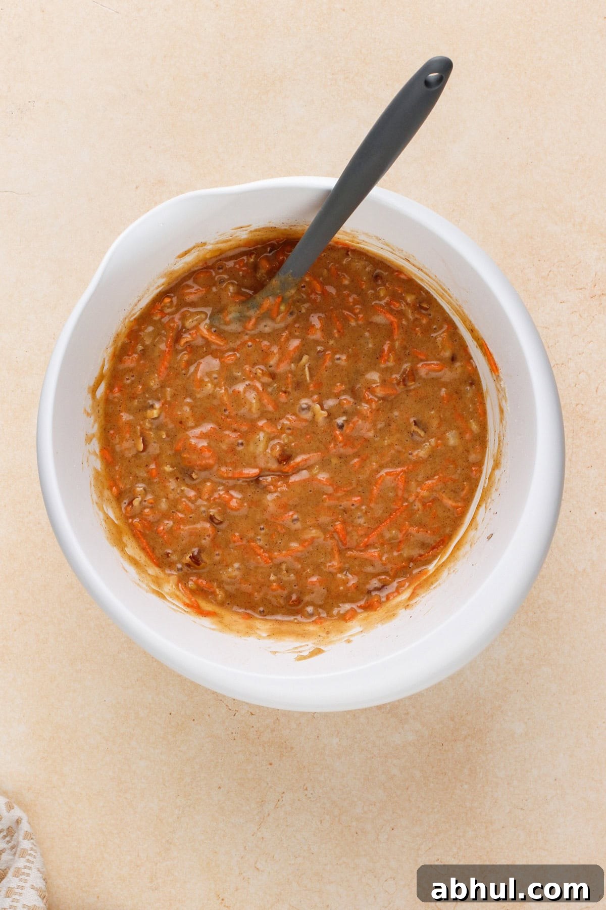 Carrot cake bar batter mixed in a white bowl.