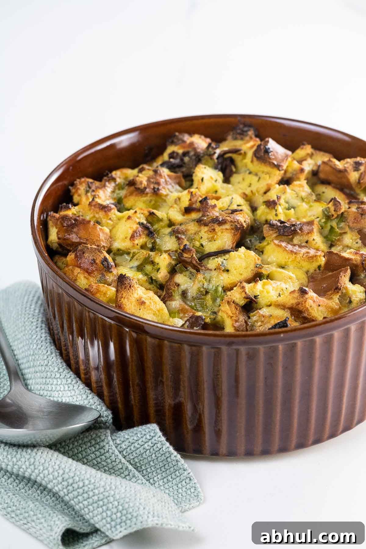 savory bread pudding with gruyere, chanterelles, and leeks in a souffle dish