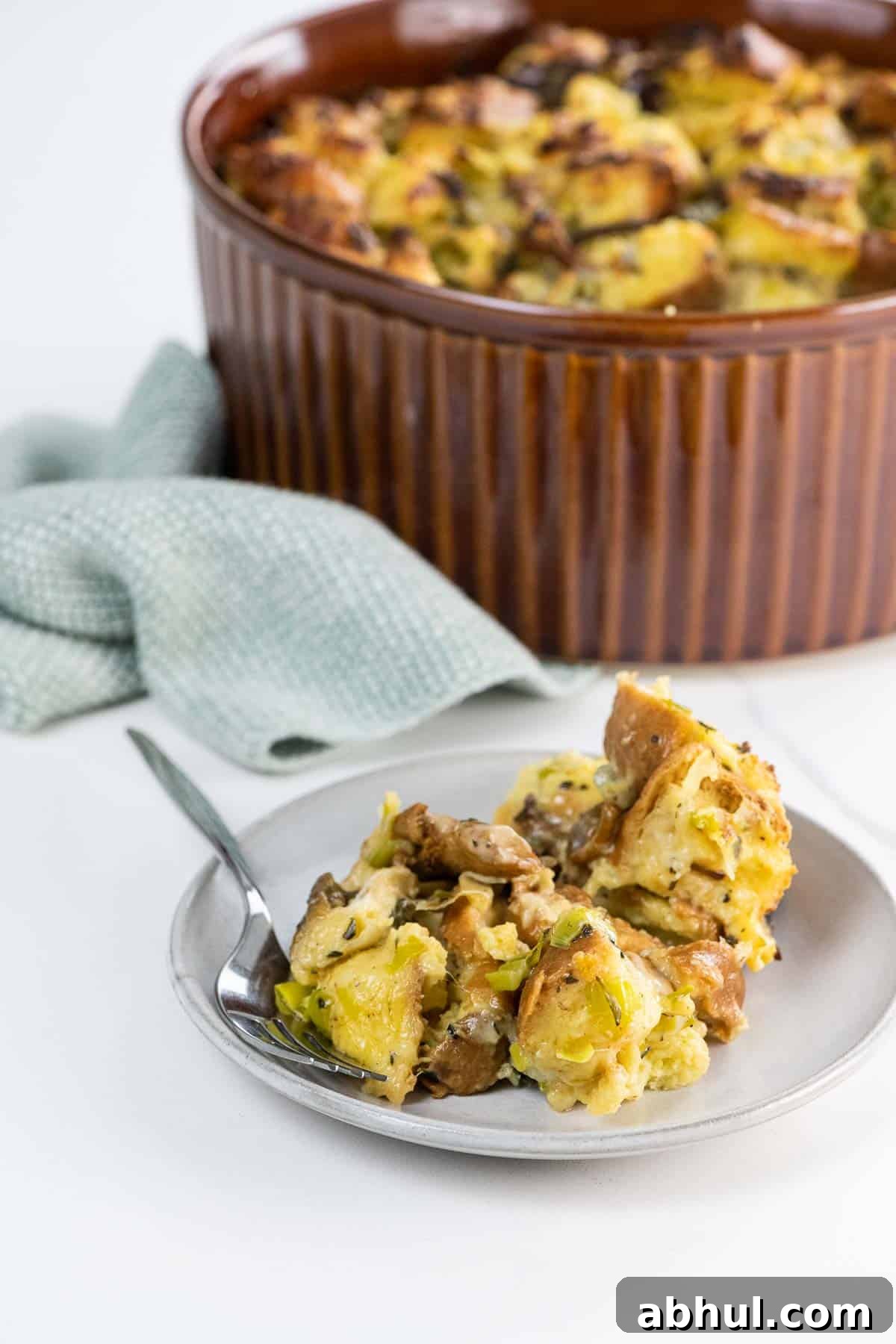 savory bread pudding with gruyere, chanterelles, and leeks in a souffle dish