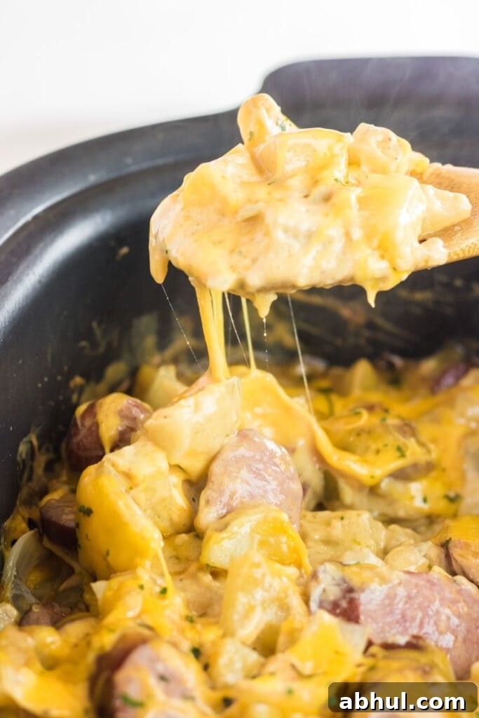 A spoon pulling out a serving of this dish.
