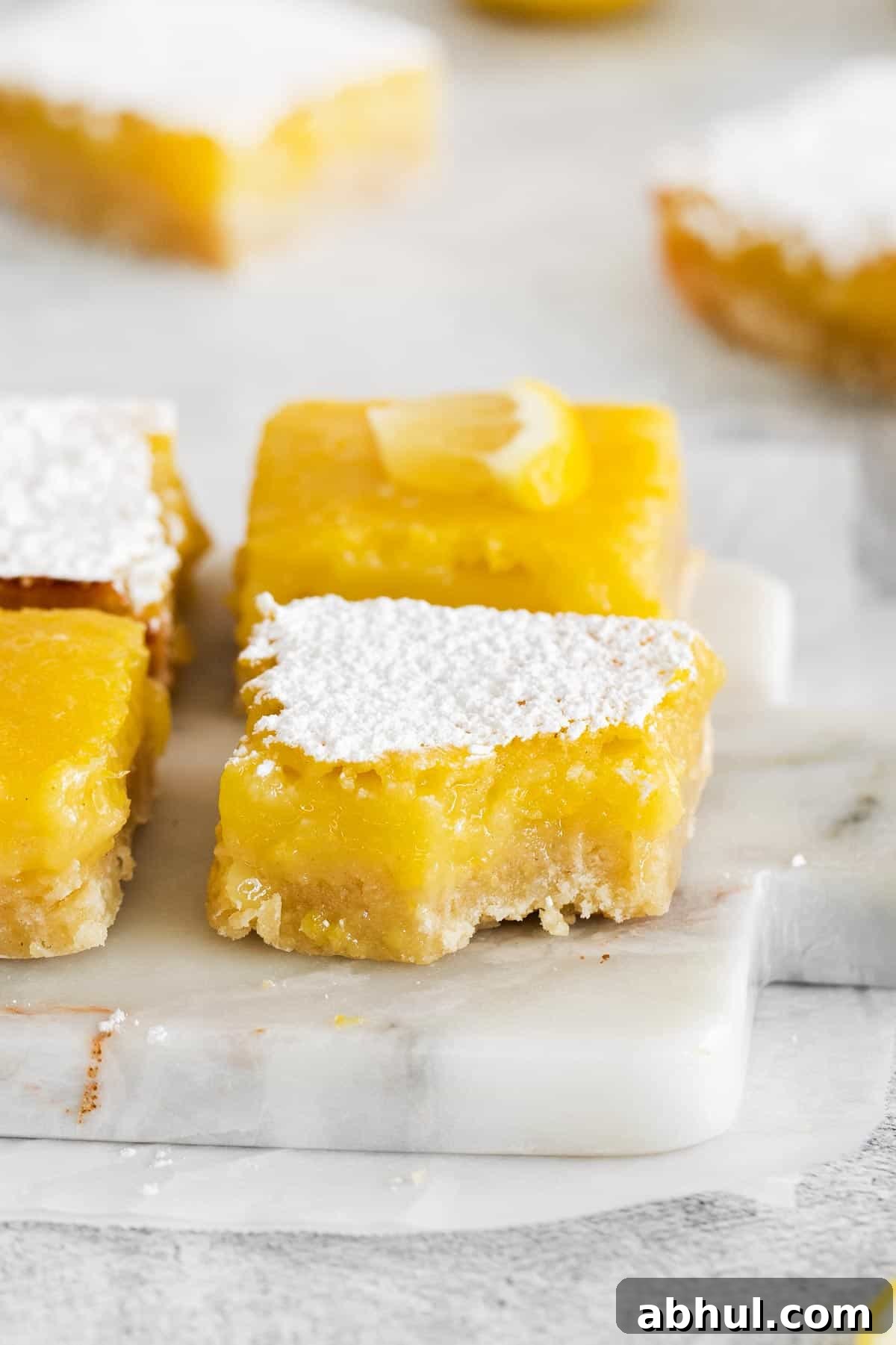 Gluten-Free Seven-Layer Bars Recipe — Chewy Chocolate Coconut Bars 12 gluten-free lemon bars stacked on a counter top