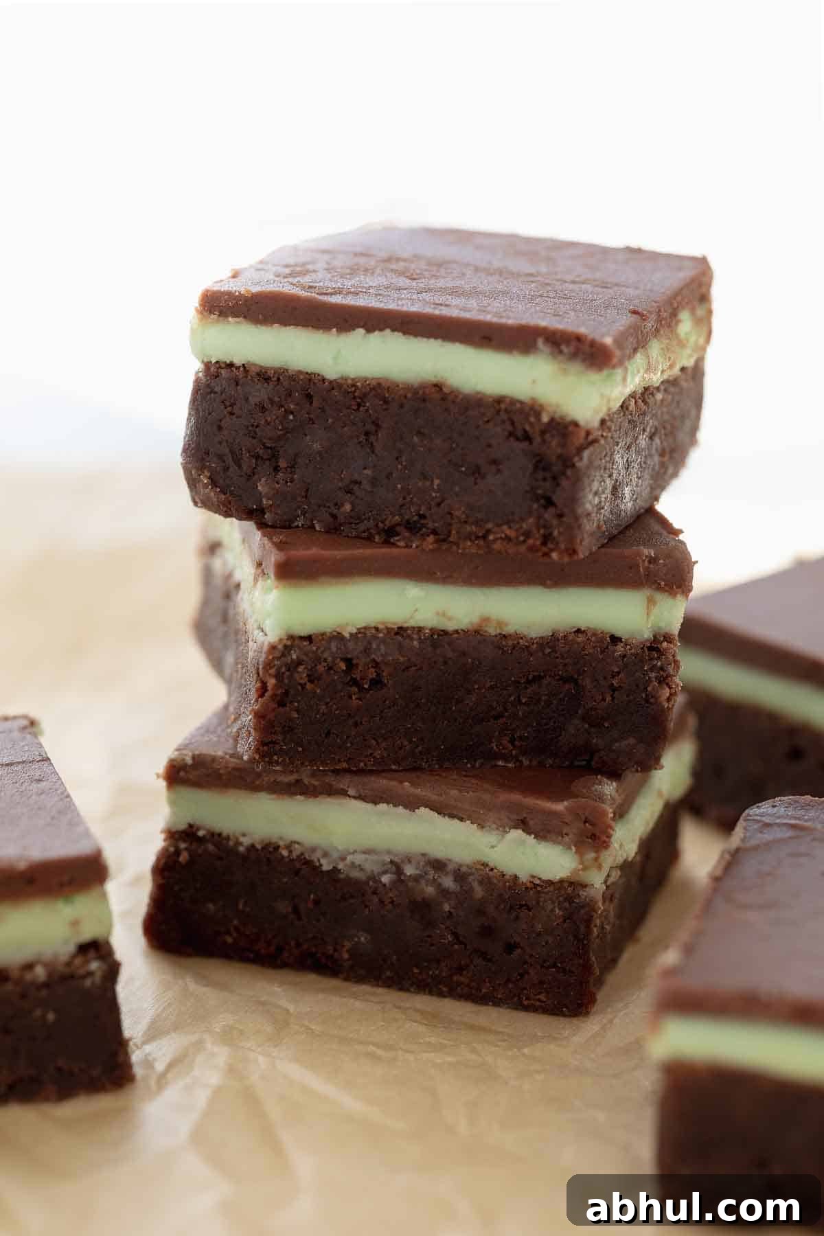 Gluten-Free Seven-Layer Bars Recipe — Chewy Chocolate Coconut Bars 17 stack of gluten free mint brownies on brown parchment paper