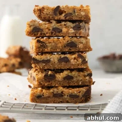Gluten-Free Seven-Layer Bars Recipe — Chewy Chocolate Coconut Bars 18 7-layer bars stacked on a cooling rack