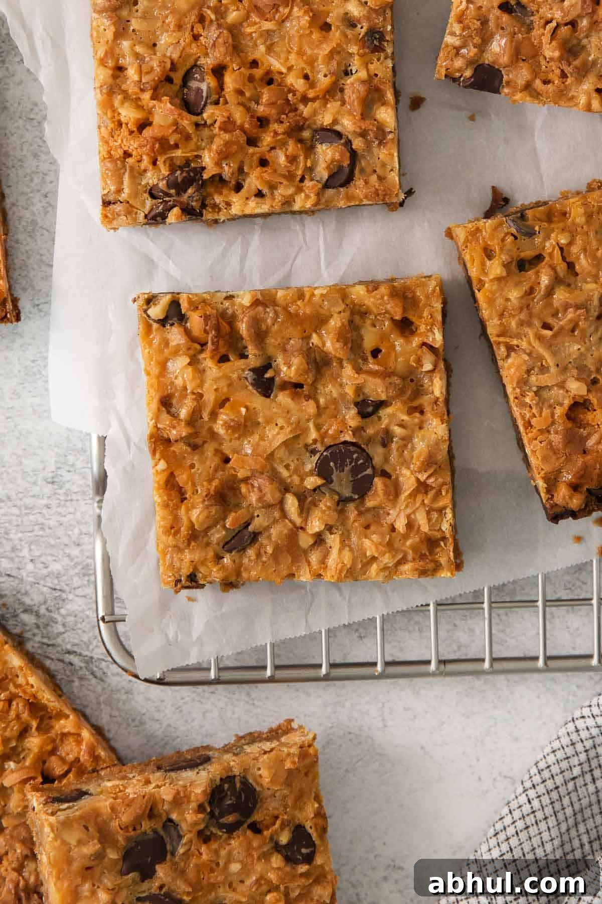 Gluten-Free Seven-Layer Bars Recipe — Chewy Chocolate Coconut Bars 10 7-layer bars cut up on a cooling rack