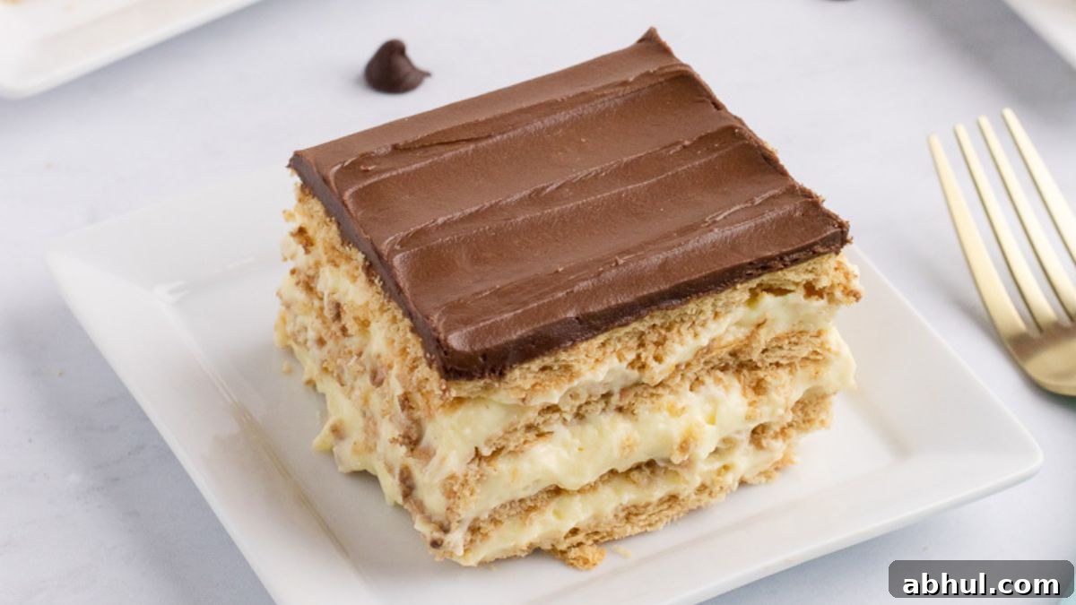 No-Bake Desserts That Satisfy Your Sweet Tooth Quickly 6 Chocolate eclair cake on a white plate with a fork on the side.