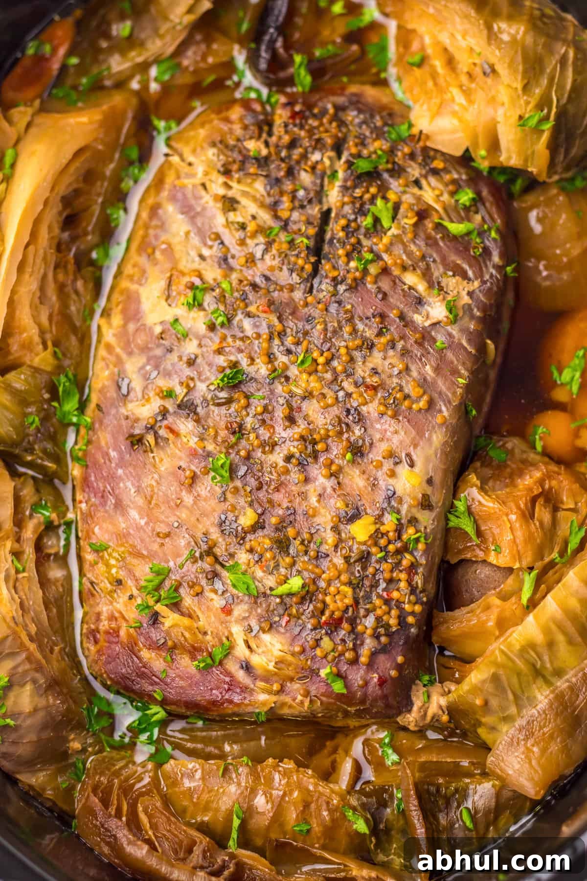 Whole corned beef and cabbage meal in crockpot.