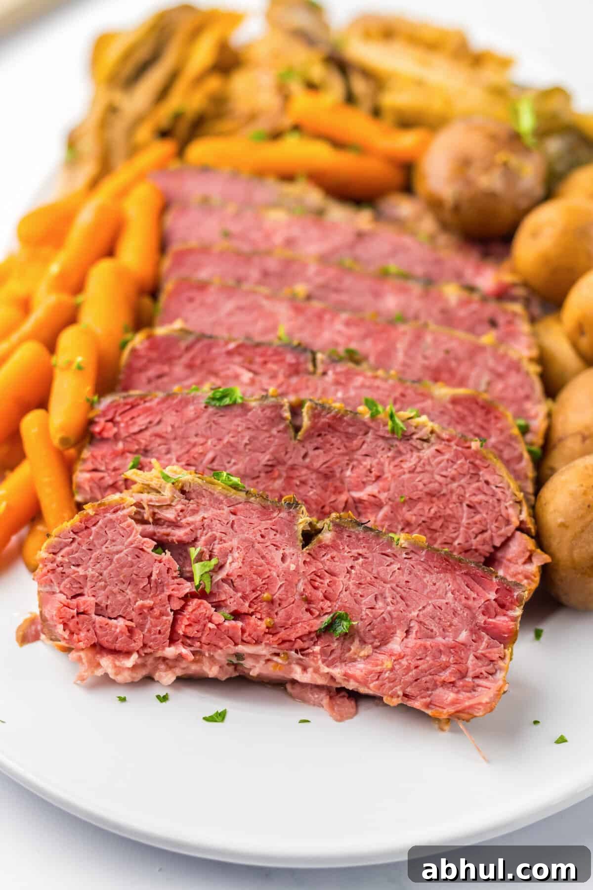 Sliced corned beef with cabbage, carrots and potatoes.