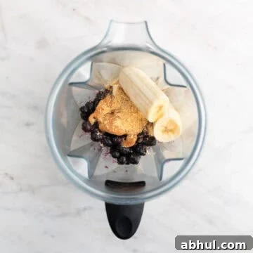 Silken tofu smoothie ingredients in a blender jar before blending.