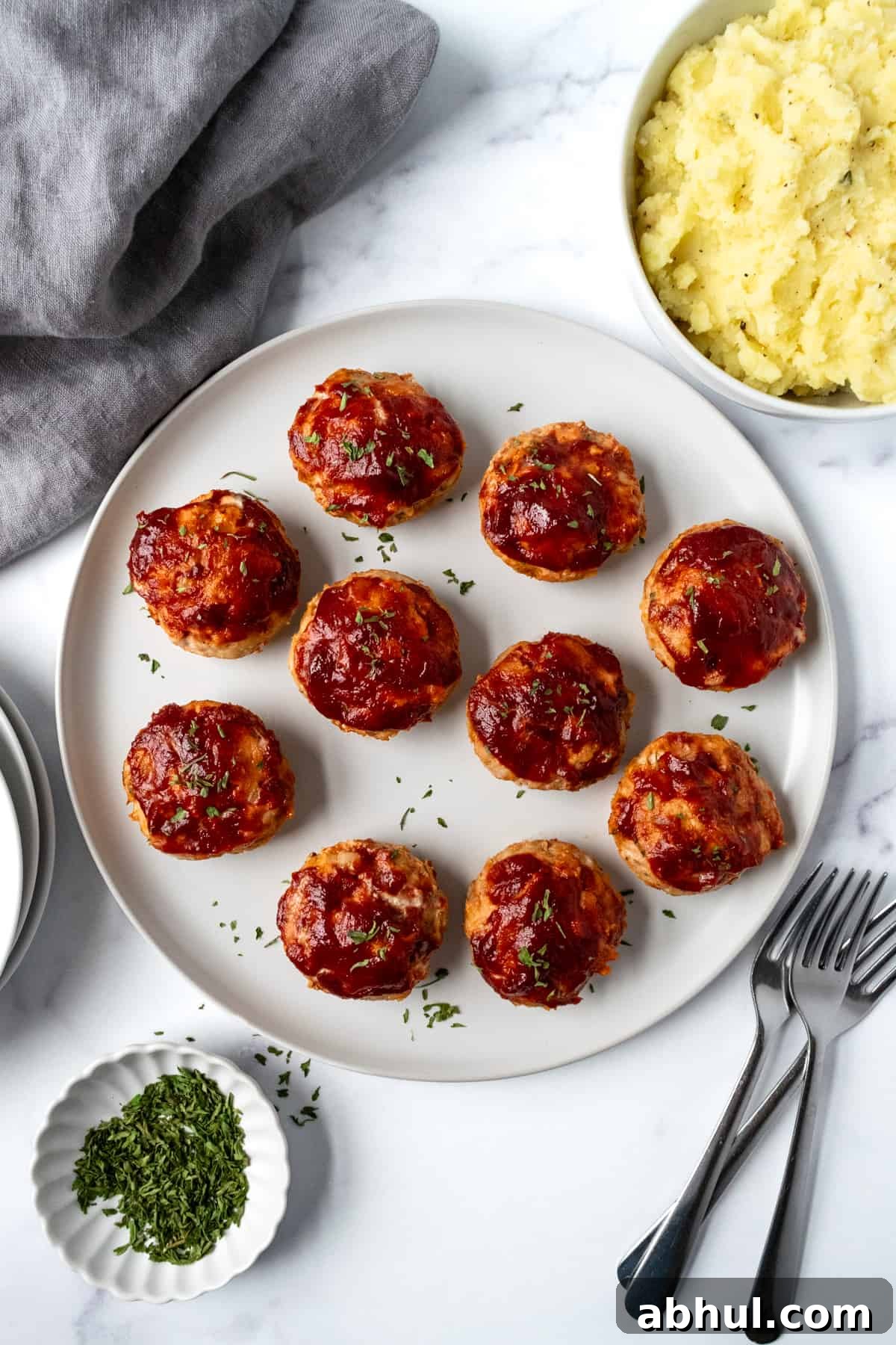 Mini Turkey Meatloaves on a white serving plate.