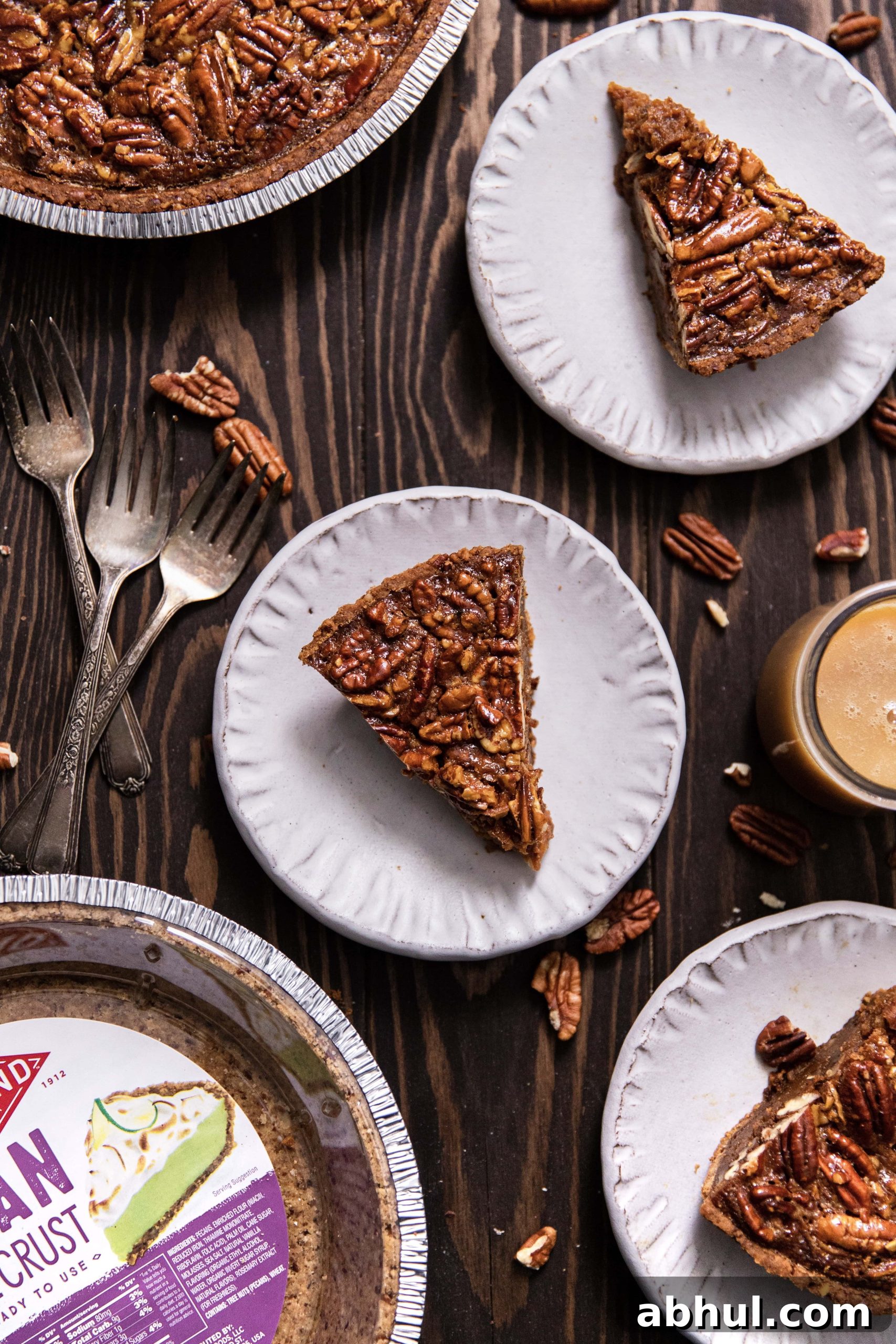 Salted caramel pecan pie with three slices of pie on plates