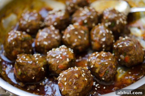 Asian meatballs in glossy pineapple glaze topped with toasted sesame seeds