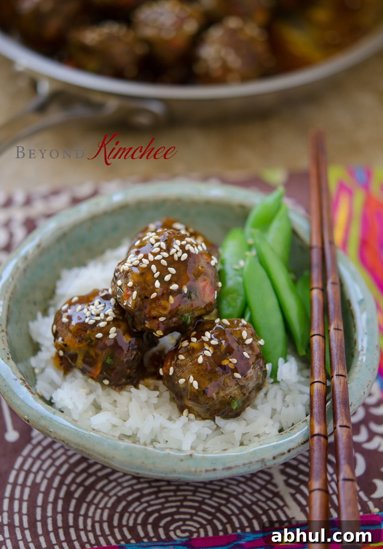 Juicy meatballs coated in pineapple soy glaze beside steamed rice