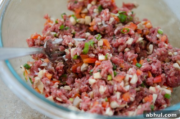 Beef, mushrooms, and green onions mixed for Asian-style meatballs