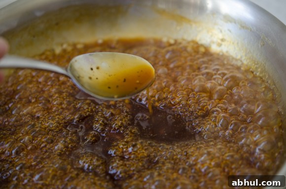 Golden pineapple glaze bubbling on the stovetop