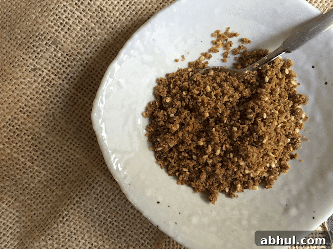 Dukkah in an off white bowl on a burlap runner.