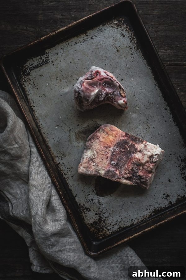 frozen bones on a cookie sheet ready for roasting before cooking into bone broth