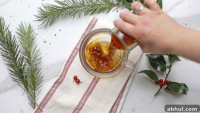 pouring a shot of strong coffee in a mug on a white and red stripped towel. Greenery surrounds the mug.