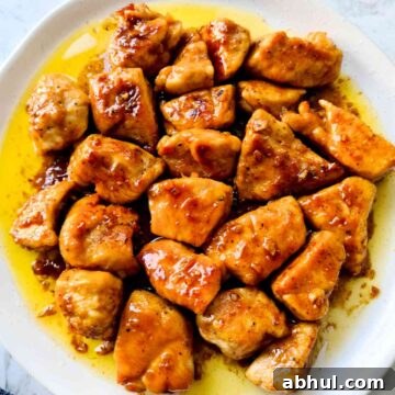 Close up plate of glossy glazed chicken bite-sized pieces