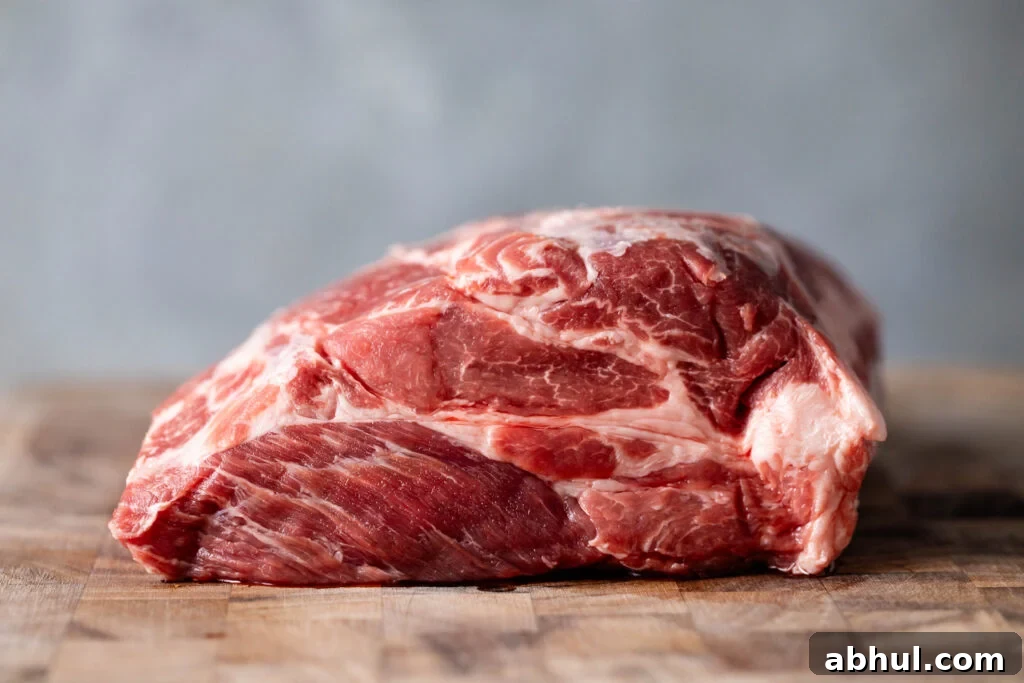 raw pork coppa roast on a cutting board