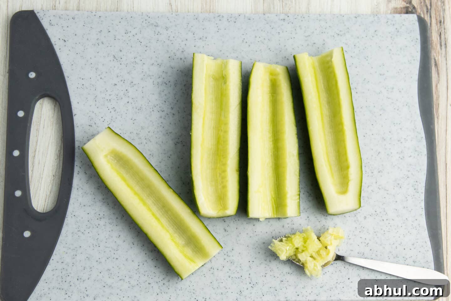 This is a picture of the cucumber seeds being scraped off.