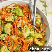 This is square picture of cucumber and carrot salad in a bowl.