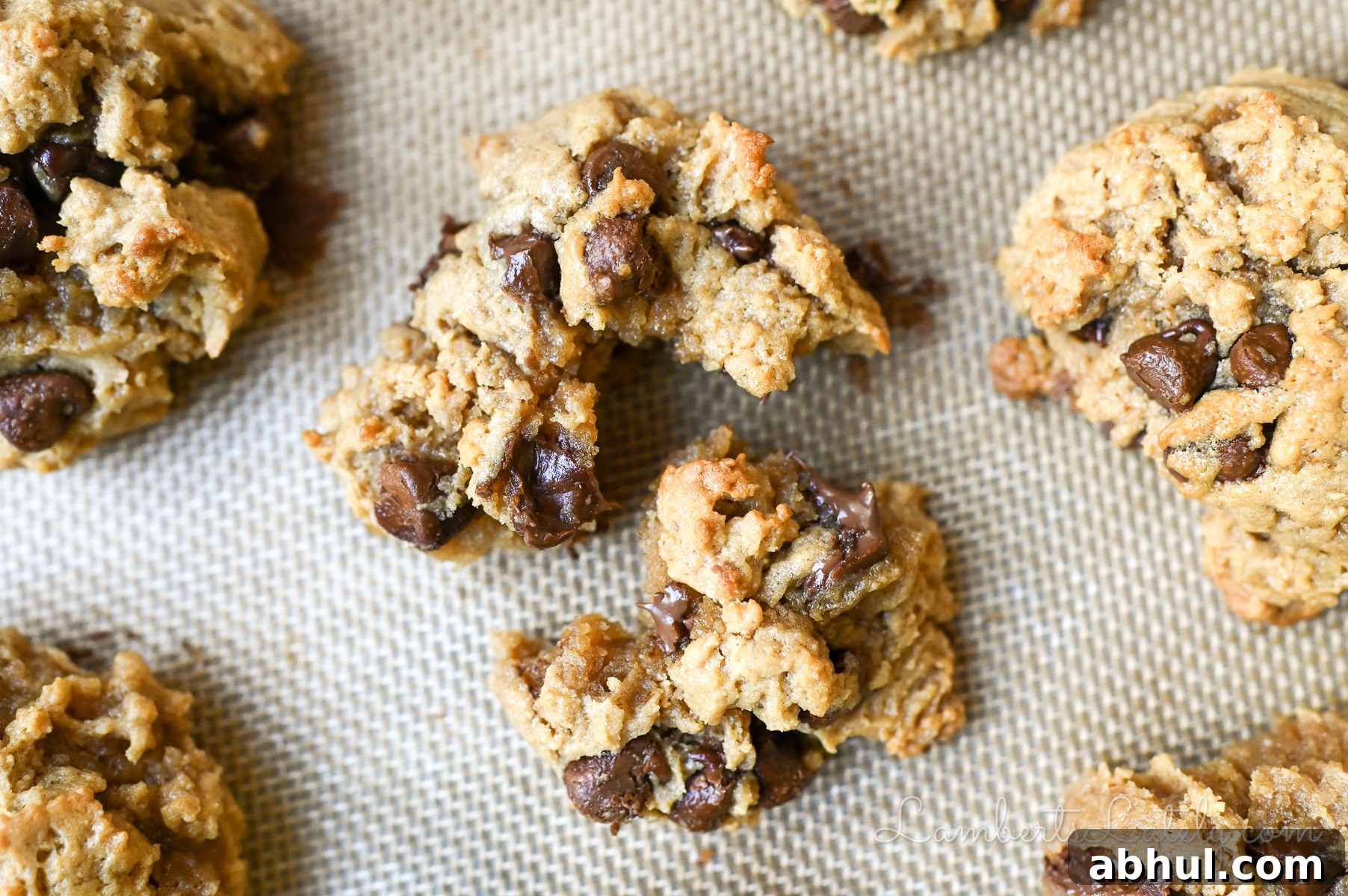 peanut butter chocolate chip cookie torn apart on a baking sheet.