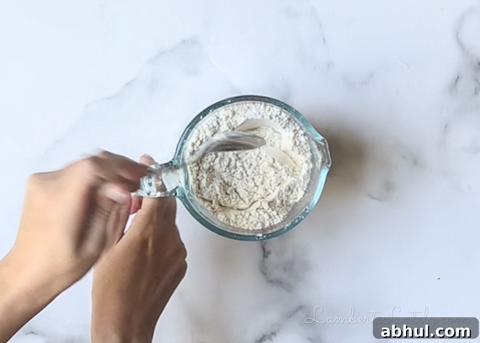 stirring dry ingredients in a measuring cup.