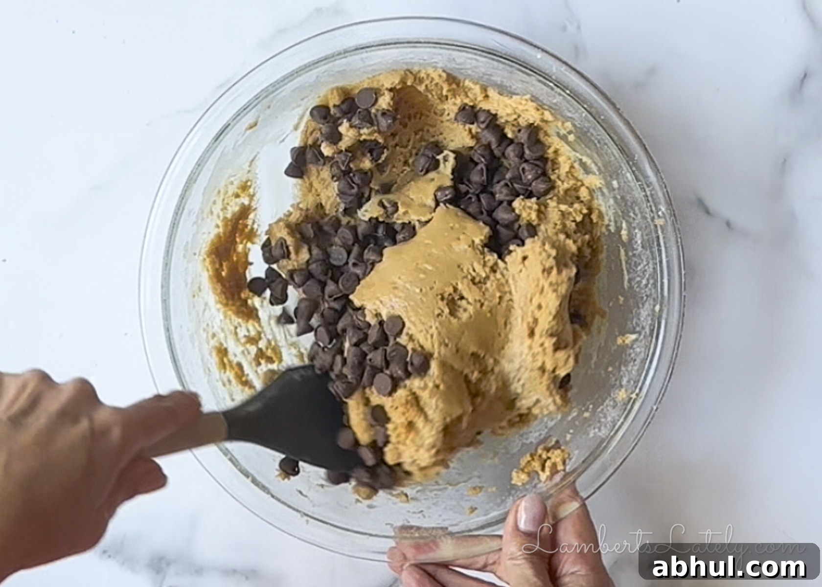 folding chocolate chips into the peanut butter cookie dough.