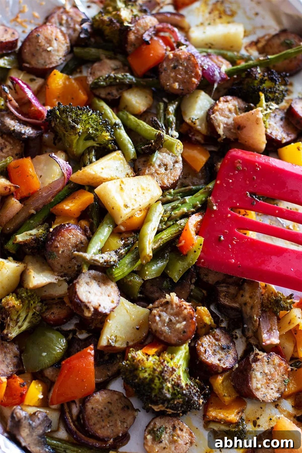 Sheet Pan Sausage with Roasted Vegetables Recipe 2 Cooked asparagus, potatoes, broccoli, sausage and smoked sausage in a sheet pan.