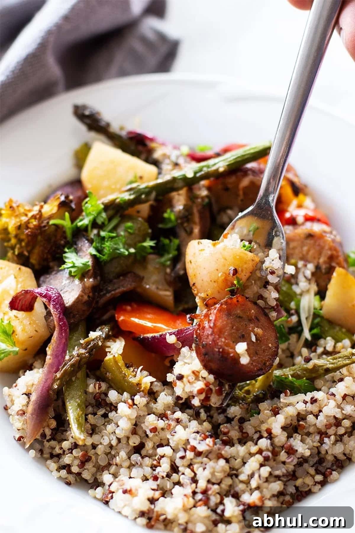 Sheet Pan Sausage with Roasted Vegetables Recipe 10 Fork with smoked sausage, potatoes, asparagus, and broccoli served with quinoa.