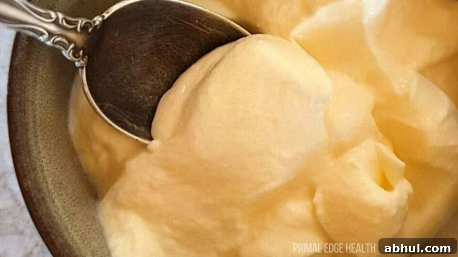 A spoon dipping into a bowl of cheesecake fluff.