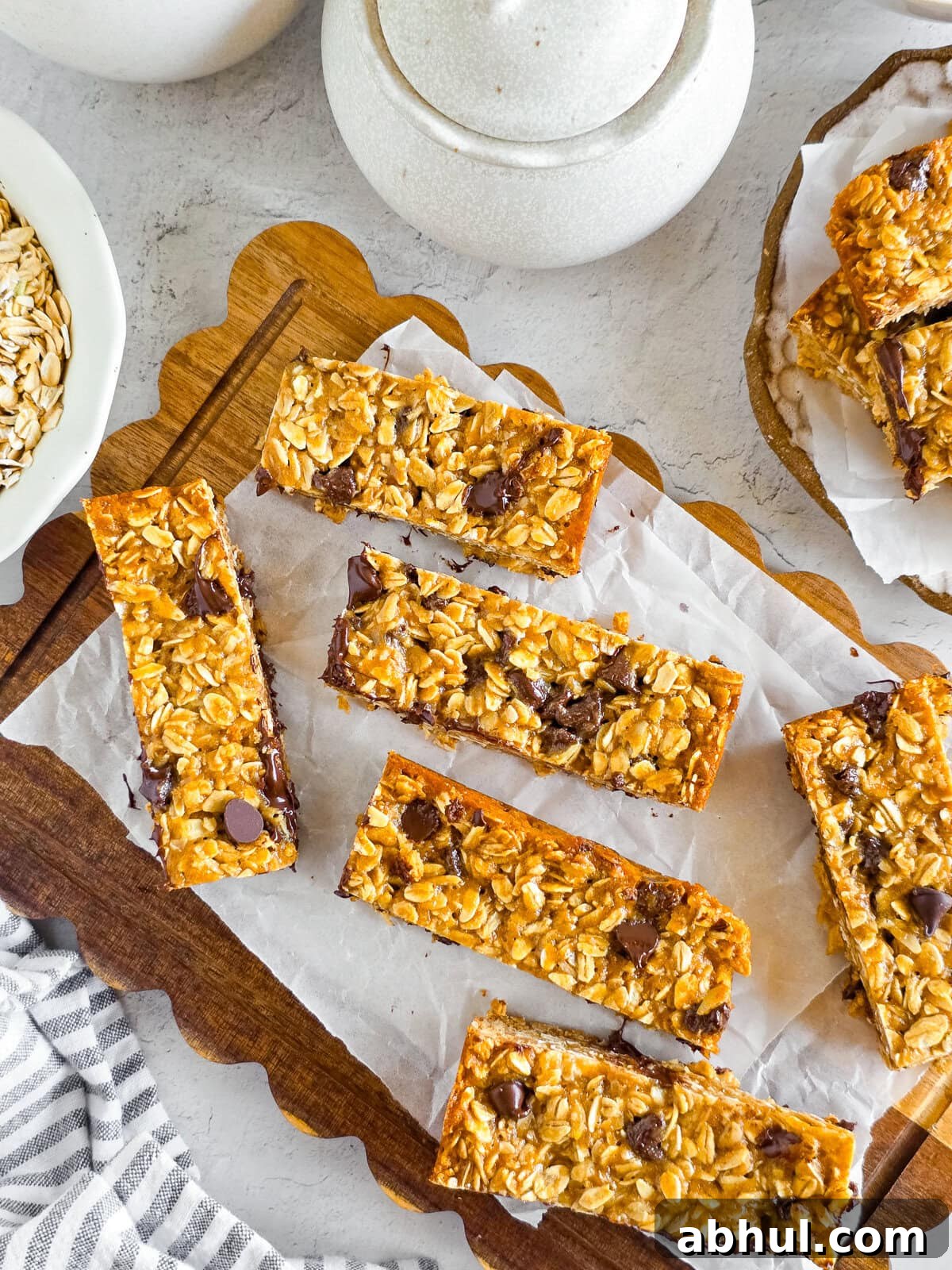 Chewy Einkorn Granola Bars with oats and chocolate chips, on parchment paper.