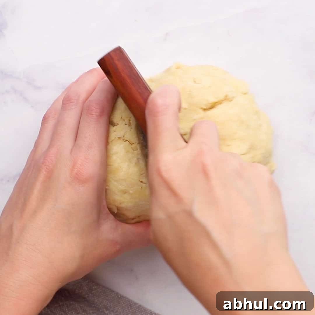 cutting the dough in two equal halves