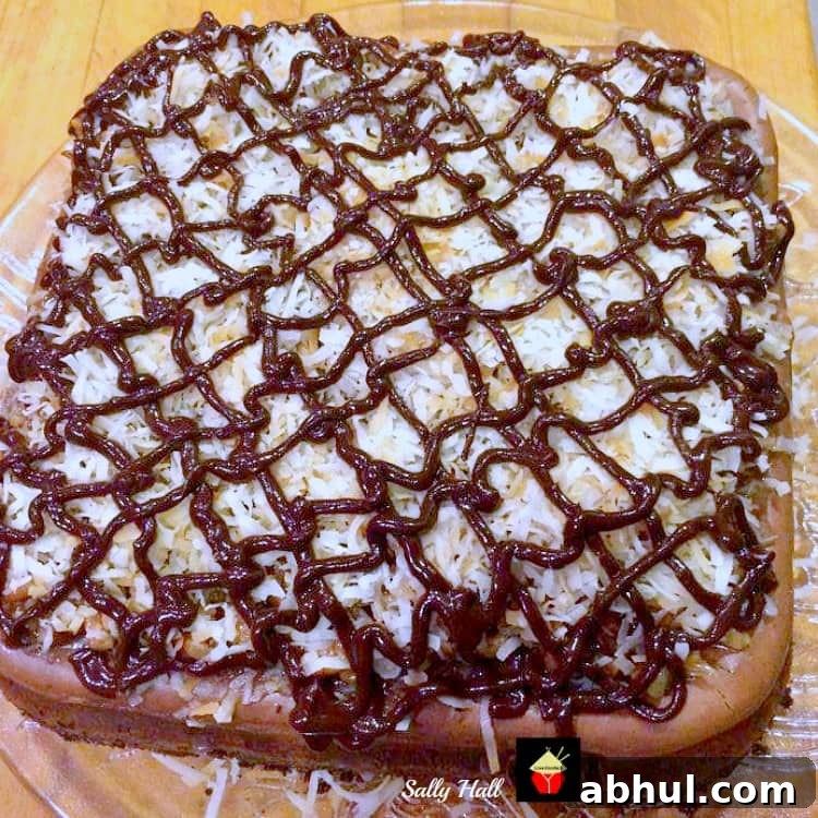 German Chocolate Cheesecake, a popular baked rich chocolate cheesecake, baked on a buttery crust and topped with pecans, coconut and chocolate. Perfect for celebrations
