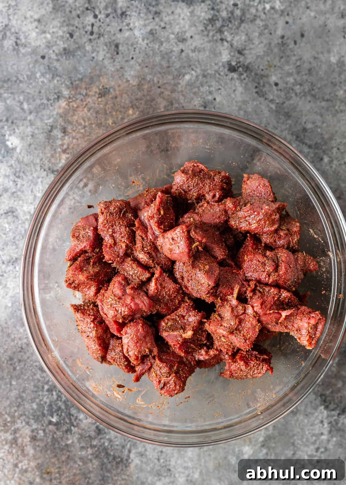 overhead process shot: seasoned beef after being tossed to coat