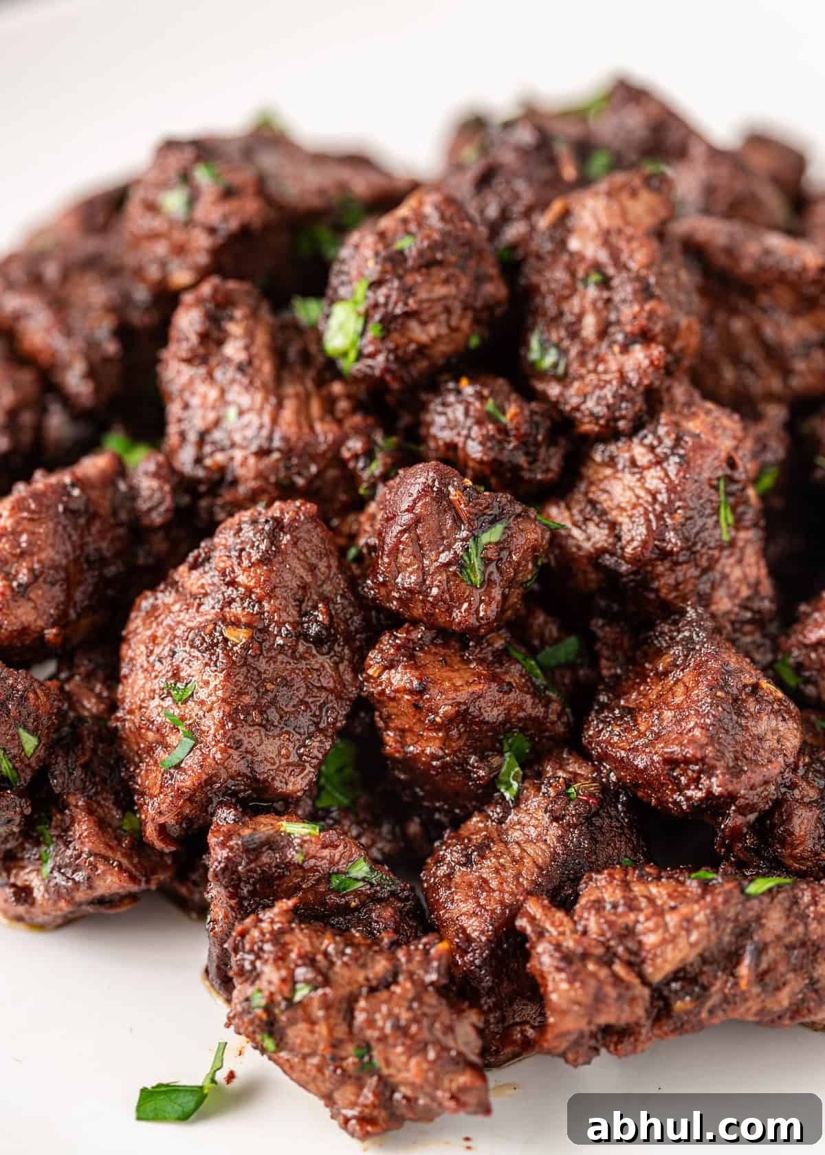 closeup: crispy cajun blackened steak with fresh herbs on top
