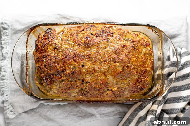 Glass loaf pan filled with baked Italian meatloaf