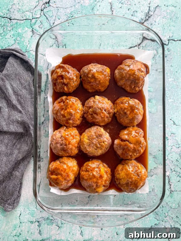 Top view of baked ham balls with sauce
