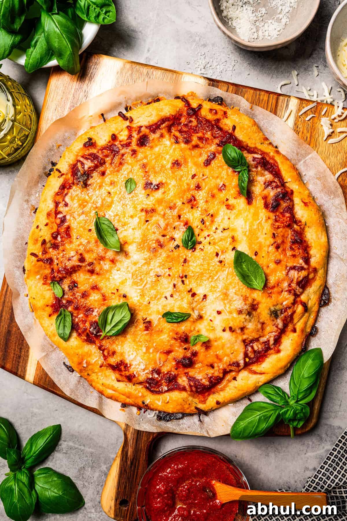 Cottage cheese pizza crust topped with tomato sauce, melty cheese, and fresh basil leaves.