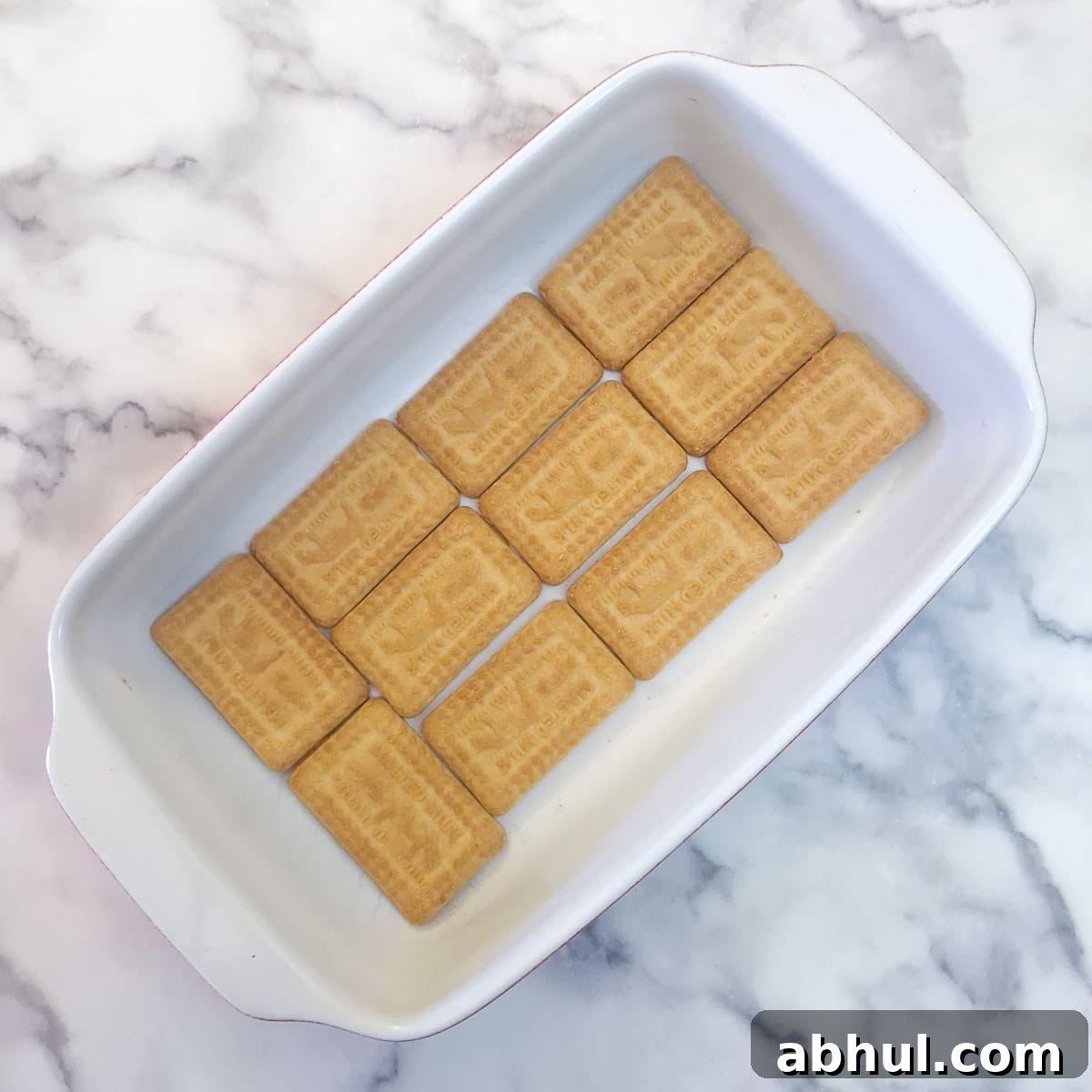 Step 7 - a layer of biscuits in a serving dish.
