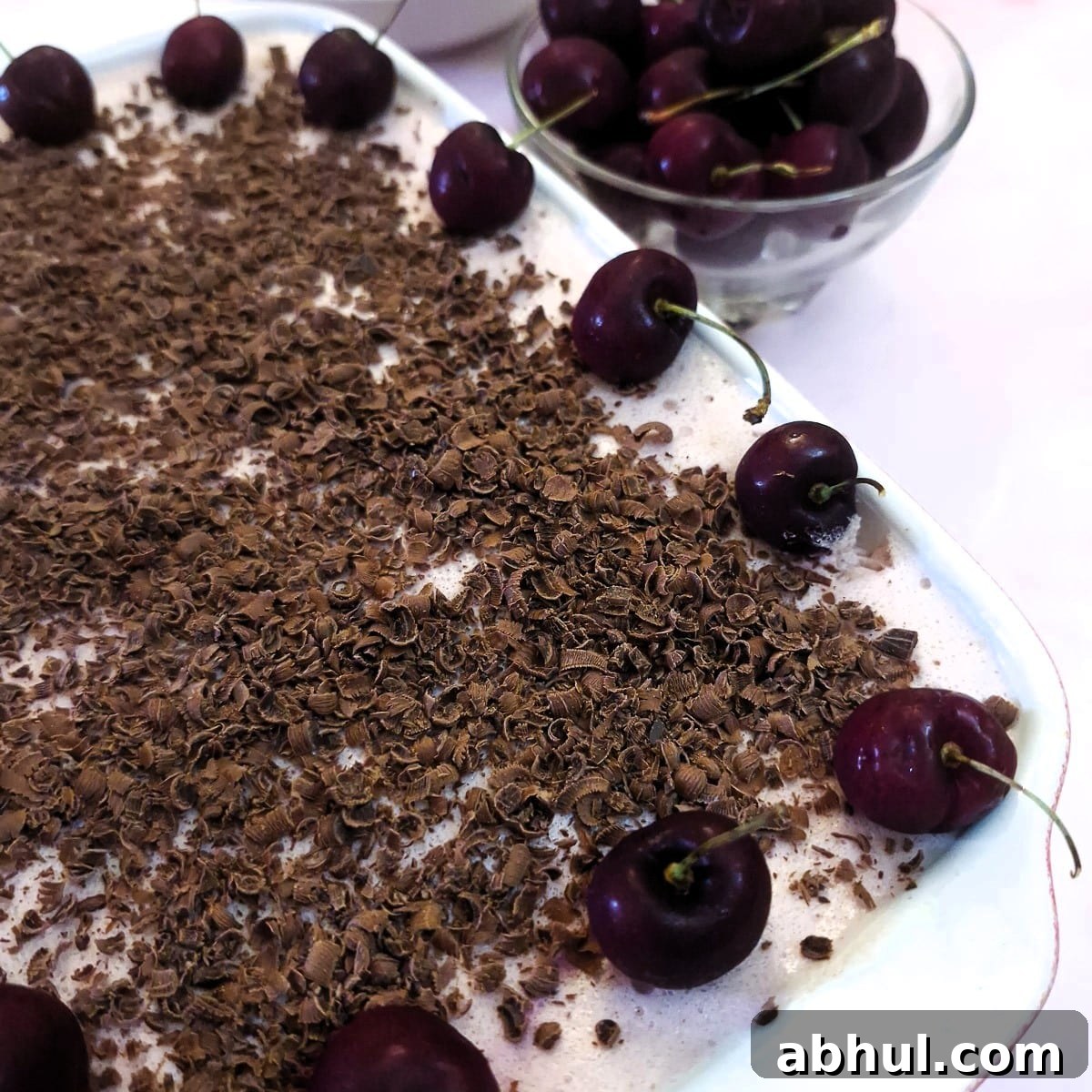 Close up of the cherry fridge tart, showing the chocolate shavings with cherries around the edge of the dish.