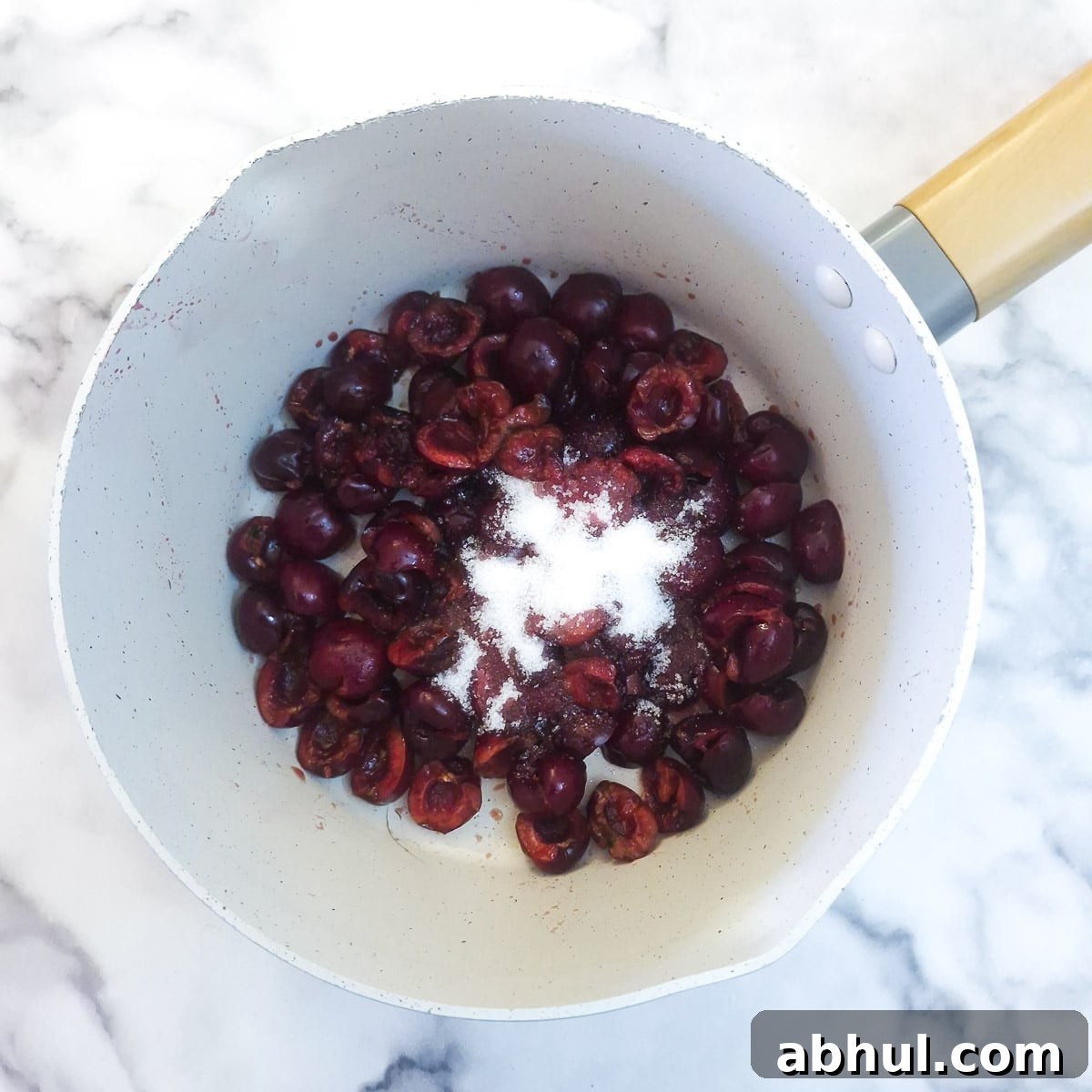 Step 2 - pitted cherries and a little sugar in a saucepan.