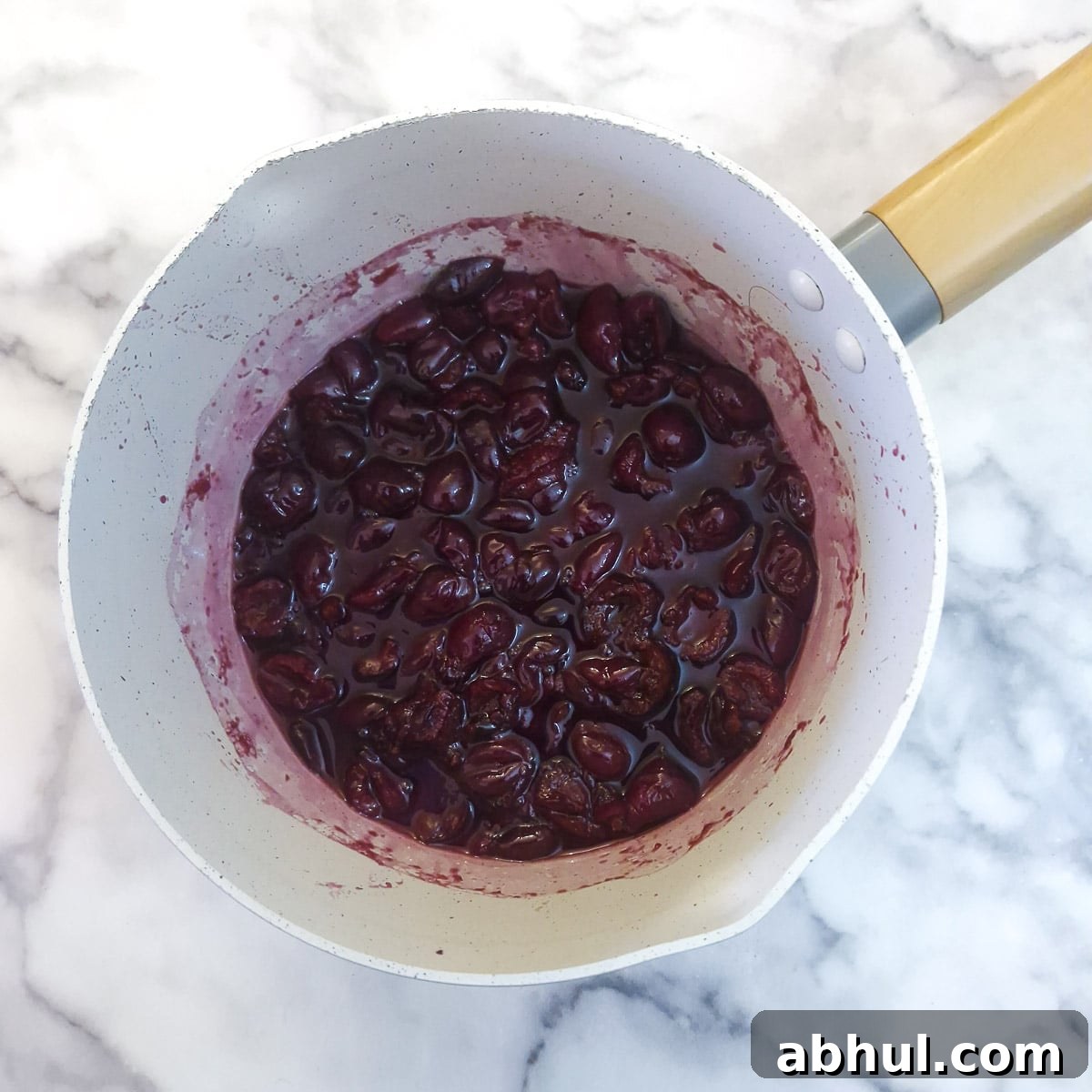 Step 3 - cherries in a saucepan having been simmered for 5 minutes to soften them.