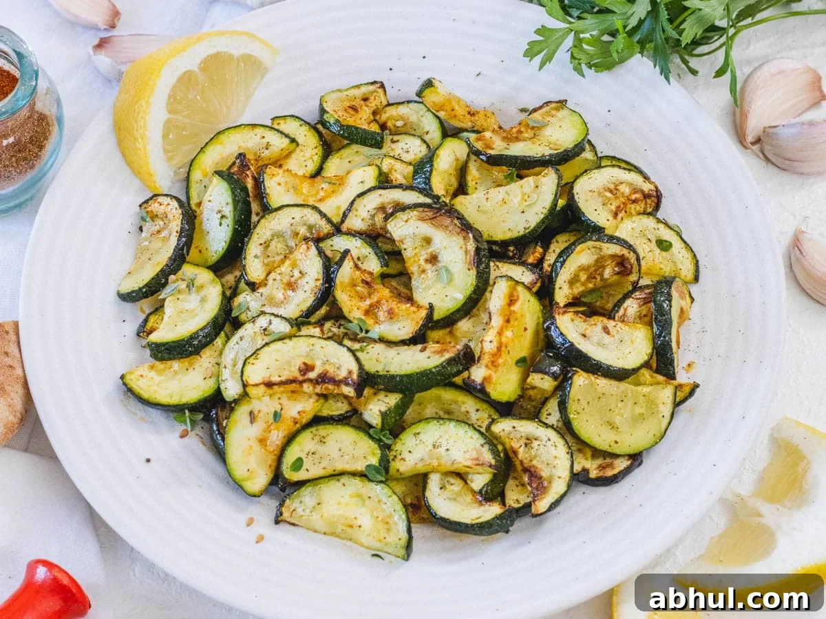 Air fryer zucchini on a plate with garlic