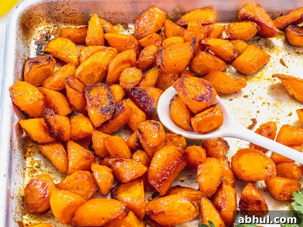 Roasted carrots with a white spoon