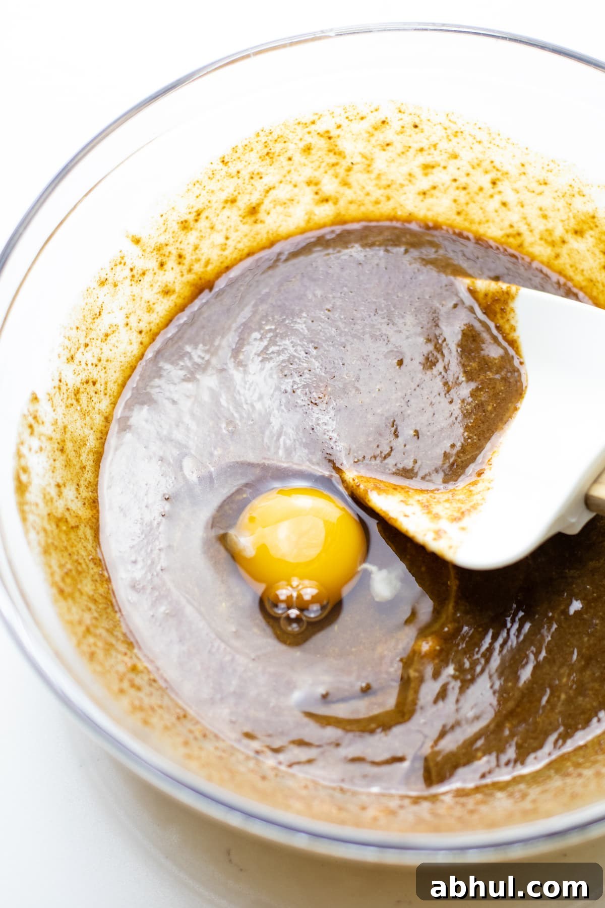 Mixing batter with a rubber spatula.