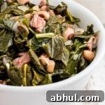 Close up of a bowl of southern black eyed peas and collard greens.