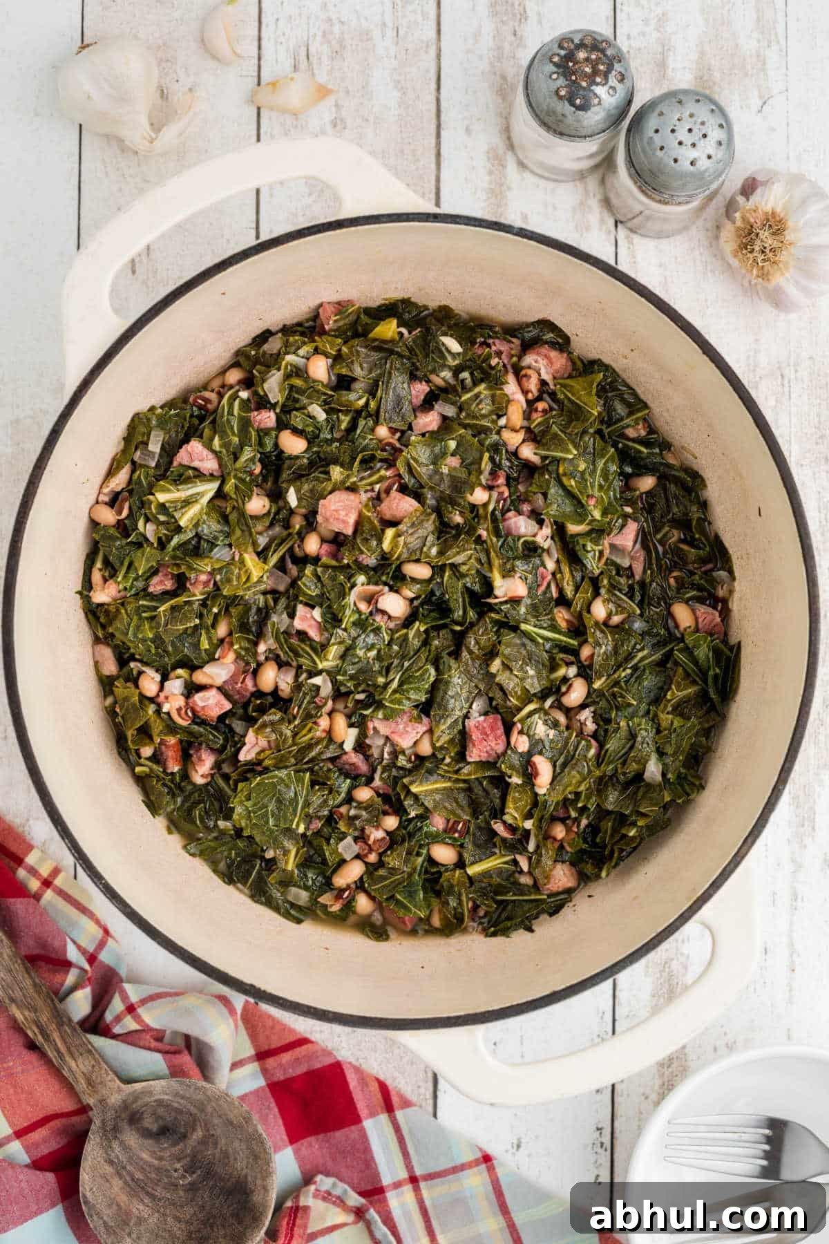Overhead shot of a Dutch Oven full of black eyed peas and collard greens.